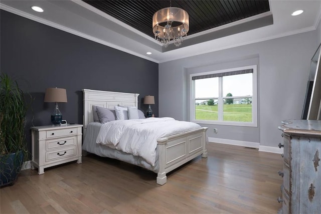 14423 N 145th St, Basehor, KS 66007 - bedroom featuring a tray ceiling, a chandelier, wood finished floors, ornamental molding, and recessed lighting