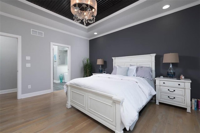 14423 N 145th St, Basehor, KS 66007 - bedroom featuring a tray ceiling, a chandelier, wood finished floors, crown molding, and recessed lighting