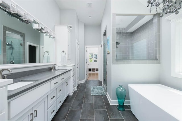 14423 N 145th St, Basehor, KS 66007 - full bath featuring a stall shower, double vanity, a freestanding tub, and healthy amount of natural light