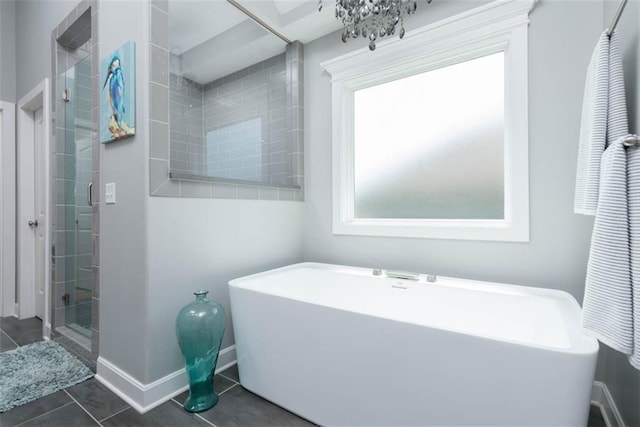 14423 N 145th St, Basehor, KS 66007 - bathroom with a freestanding tub, tile patterned floors, and a shower stall