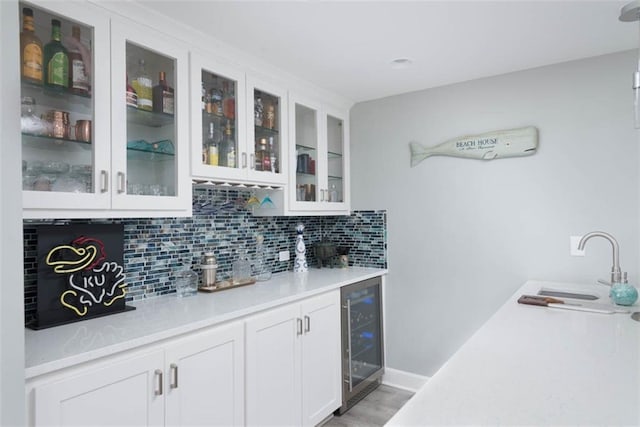 14423 N 145th St, Basehor, KS 66007 - indoor bar featuring beverage cooler, tasteful backsplash, and light wood-style floors