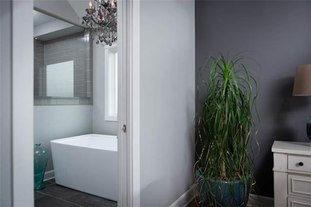 14423 N 145th St, Basehor, KS 66007 - bathroom with a freestanding bath, vanity, a chandelier, and tile patterned flooring