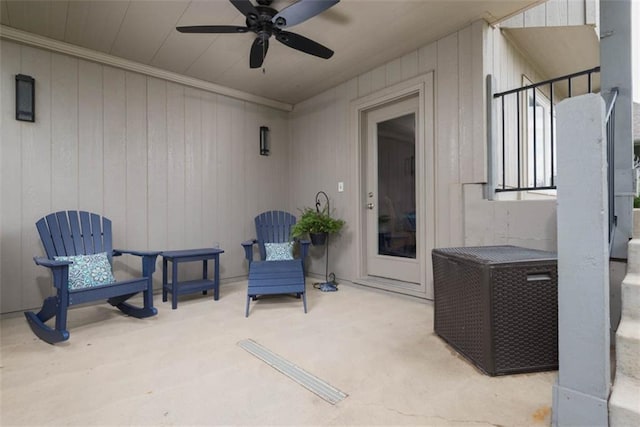 14423 N 145th St, Basehor, KS 66007 - sitting room with a ceiling fan, wood walls, ornamental molding, and carpet flooring