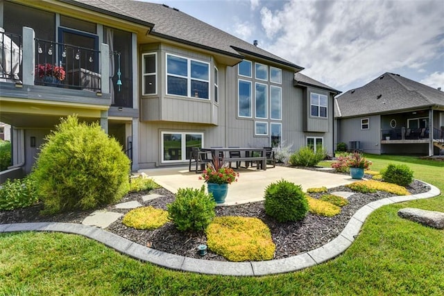 14423 N 145th St, Basehor, KS 66007 - rear view of property with a patio area and a lawn