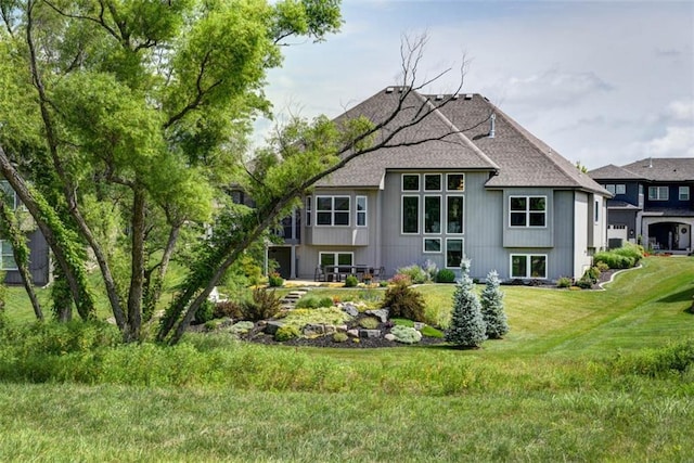 14423 N 145th St, Basehor, KS 66007 - rear view of house with roof with shingles and a lawn