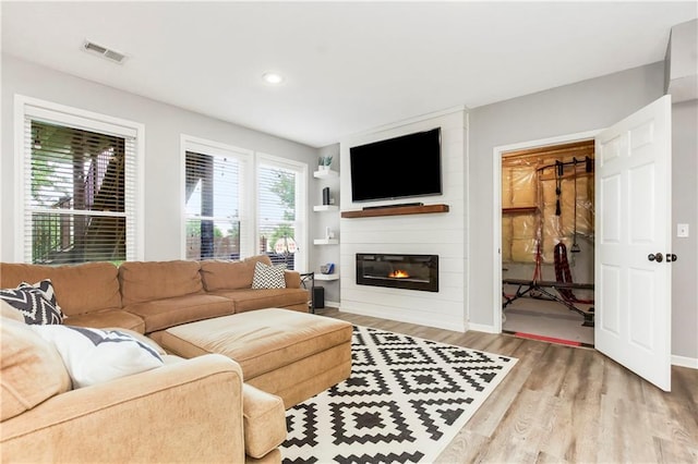 23852 W 124th Ct, Olathe, KS 66061 - living area featuring light wood-type flooring, a large fireplace, and recessed lighting