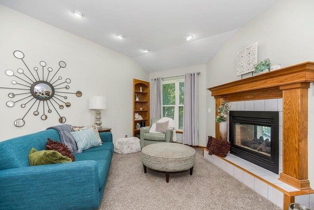1702 Aspen Ln, Excelsior Springs, MO 64024 - carpeted living area featuring lofted ceiling and a tiled fireplace