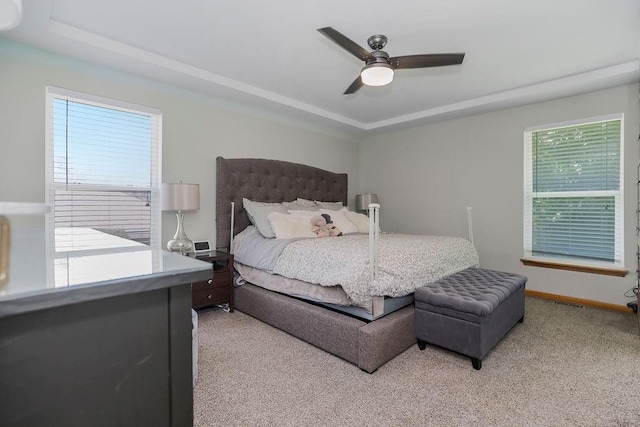 1702 Aspen Ln, Excelsior Springs, MO 64024 - bedroom featuring light carpet, a ceiling fan, and a tray ceiling