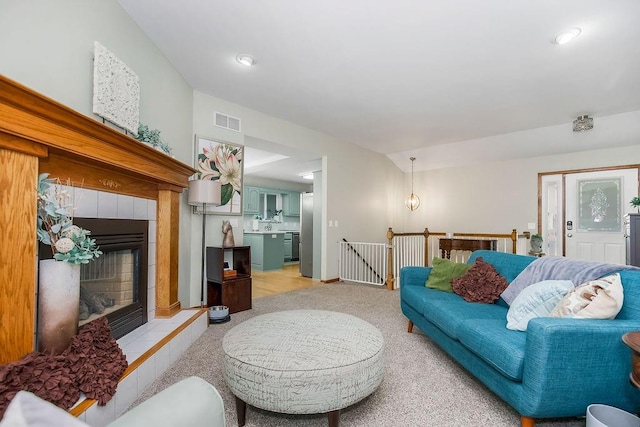 1702 Aspen Ln, Excelsior Springs, MO 64024 - living room featuring a fireplace, light colored carpet, and recessed lighting