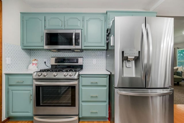 1702 Aspen Ln, Excelsior Springs, MO 64024 - kitchen with appliances with stainless steel finishes, light countertops, light wood-style flooring, and tasteful backsplash