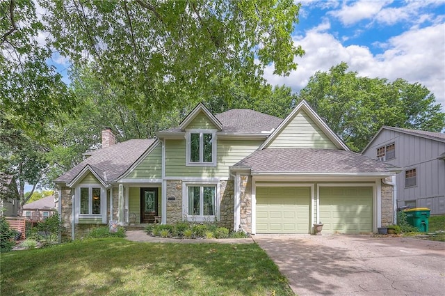 12432 Lamar Ave, Overland Park, KS 66209 - view of front of home featuring stone siding, an attached garage, a front yard, a chimney, and driveway
