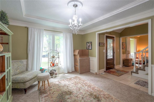 12432 Lamar Ave, Overland Park, KS 66209 - sitting room with light carpet, a chandelier, crown molding, a tray ceiling, and stairs