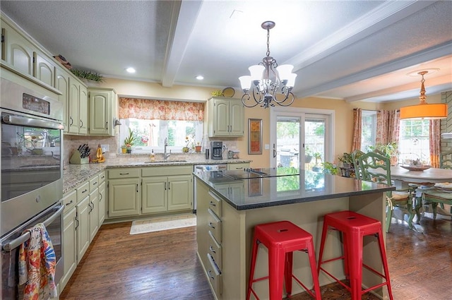 12432 Lamar Ave, Overland Park, KS 66209 - kitchen featuring beam ceiling, a kitchen breakfast bar, dark wood-type flooring, a chandelier, and backsplash