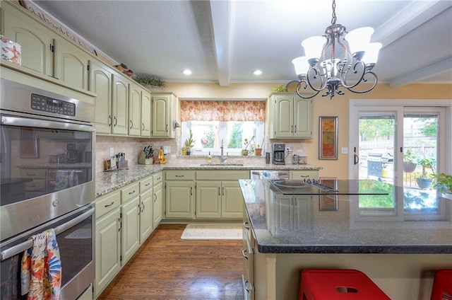 12432 Lamar Ave, Overland Park, KS 66209 - kitchen featuring stainless steel appliances, beam ceiling, backsplash, dark wood-style floors, and a chandelier