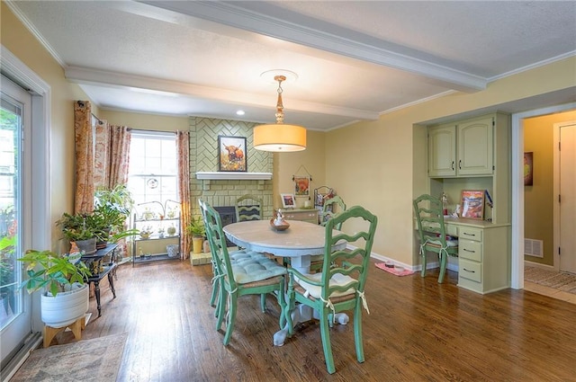 12432 Lamar Ave, Overland Park, KS 66209 - dining room featuring dark wood finished floors, a fireplace, ornamental molding, and beam ceiling