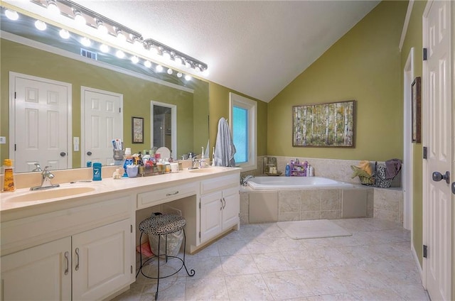 12432 Lamar Ave, Overland Park, KS 66209 - bathroom featuring a garden tub, double vanity, vaulted ceiling, and a textured ceiling
