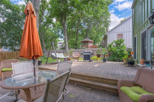 12432 Lamar Ave, Overland Park, KS 66209 - wooden terrace featuring outdoor dining area, a fenced backyard, and grilling area