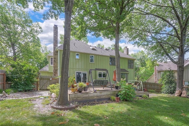 12432 Lamar Ave, Overland Park, KS 66209 - rear view of house with a chimney, board and batten siding, a fenced backyard, french doors, and a patio