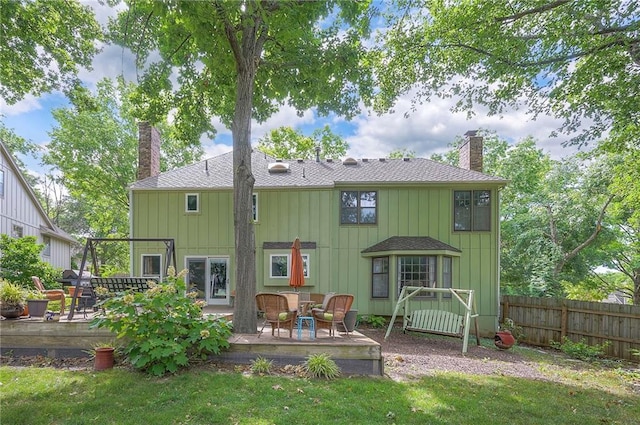 12432 Lamar Ave, Overland Park, KS 66209 - back of house with a chimney, a wooden deck, and a shingled roof