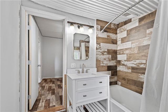 921 E Vine St, Rich Hill, MO 64779 - bathroom with shower / bath combination with curtain, vanity, wood finished floors, and wooden walls