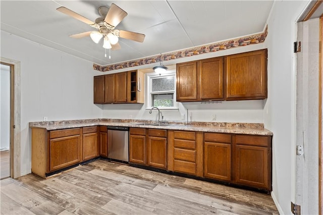921 E Vine St, Rich Hill, MO 64779 - kitchen with stainless steel dishwasher, brown cabinets, light wood-type flooring, ceiling fan, and open shelves