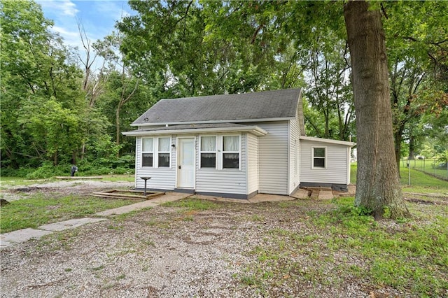 921 E Vine St, Rich Hill, MO 64779 - bungalow-style home with a shingled roof