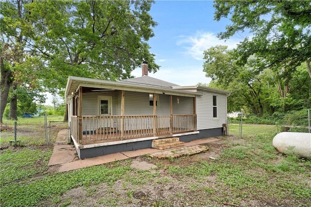 921 E Vine St, Rich Hill, MO 64779 - view of front of property featuring a porch and a chimney