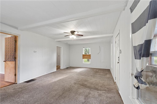921 E Vine St, Rich Hill, MO 64779 - carpeted spare room with plenty of natural light, beam ceiling, and a ceiling fan