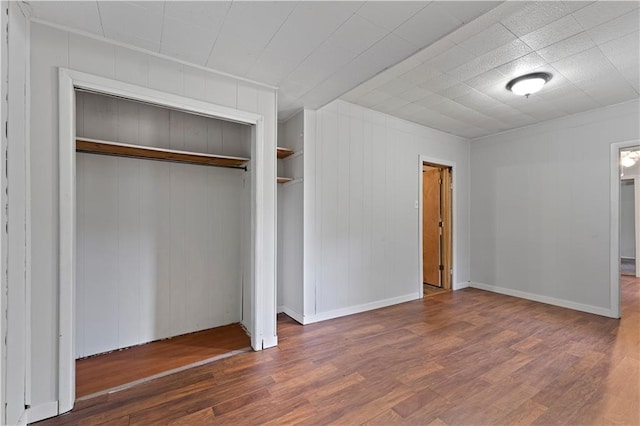 921 E Vine St, Rich Hill, MO 64779 - unfurnished bedroom with wood finished floors and a closet