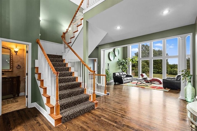 14409 Grandview St, Overland Park, KS 66221 - stairs featuring wood finished floors, a towering ceiling, and recessed lighting