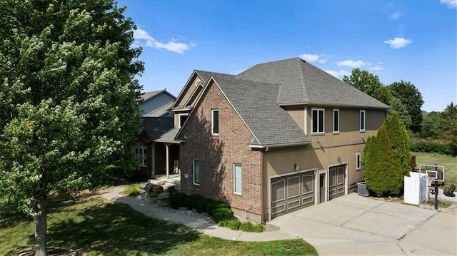 14409 Grandview St, Overland Park, KS 66221 - view of home's exterior with brick siding, driveway, a garage, and a shingled roof
