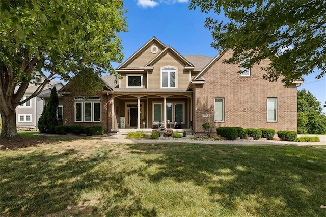14409 Grandview St, Overland Park, KS 66221 - view of front of property featuring covered porch, brick siding, and a front yard