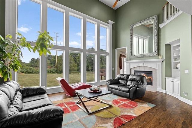 14409 Grandview St, Overland Park, KS 66221 - living area featuring a high end fireplace, wood finished floors, a high ceiling, and built in features