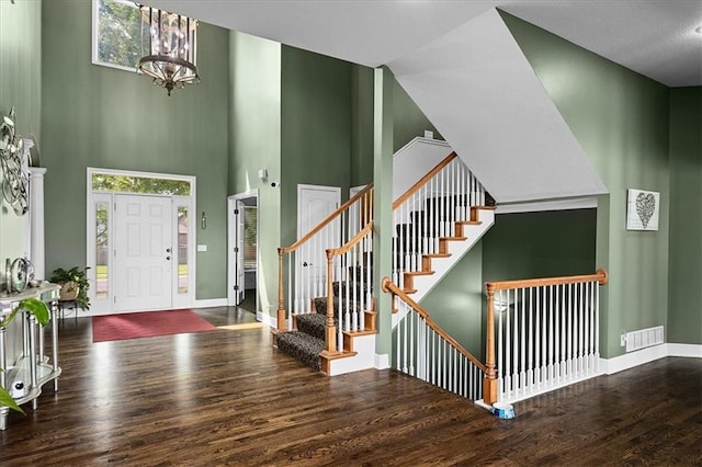 14409 Grandview St, Overland Park, KS 66221 - entrance foyer featuring wood finished floors, a high ceiling, a chandelier, and stairway