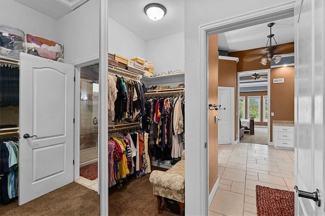 14409 Grandview St, Overland Park, KS 66221 - spacious closet with a ceiling fan, light colored carpet, and light tile patterned floors