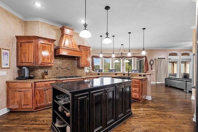 14409 Grandview St, Overland Park, KS 66221 - kitchen featuring premium range hood, dark wood-style flooring, a peninsula, ornamental molding, and a kitchen island