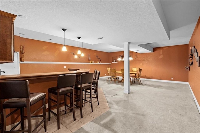 14409 Grandview St, Overland Park, KS 66221 - community bar area featuring a textured ceiling, decorative light fixtures, light colored carpet, and freestanding refrigerator