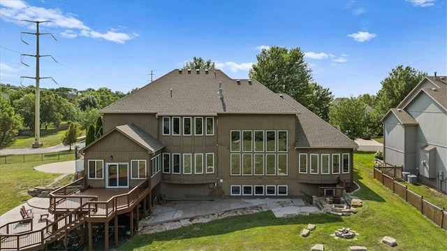14409 Grandview St, Overland Park, KS 66221 - back of house featuring a shingled roof and a patio area