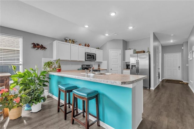 20367 W 193rd Ter, Spring Hill, KS 66083 - kitchen featuring appliances with stainless steel finishes, a peninsula, dark wood finished floors, light countertops, and recessed lighting