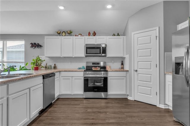 20367 W 193rd Ter, Spring Hill, KS 66083 - kitchen with appliances with stainless steel finishes, white cabinetry, tasteful backsplash, light countertops, and lofted ceiling
