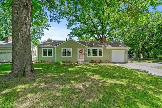 8815 W 81st St, Overland Park, KS 66204 - ranch-style house with an attached garage, driveway, a front yard, and a chimney