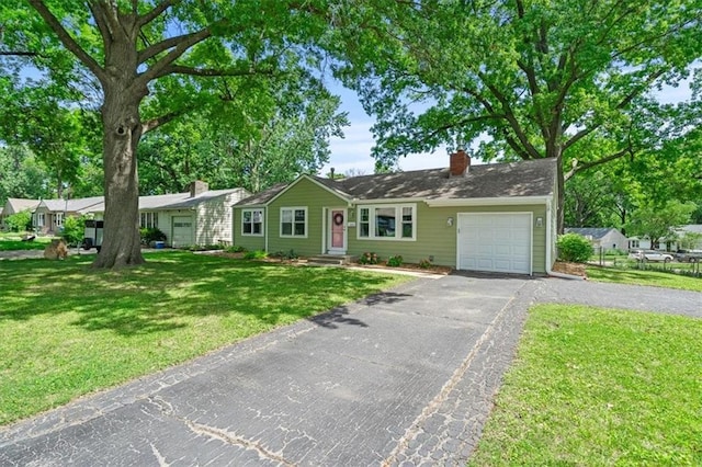 8815 W 81st St, Overland Park, KS 66204 - ranch-style house featuring asphalt driveway, a garage, a chimney, and a front yard