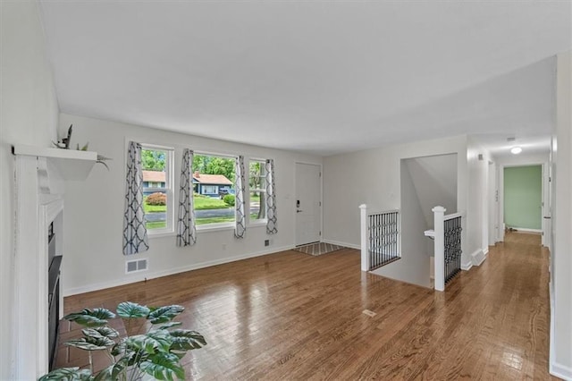 8815 W 81st St, Overland Park, KS 66204 - unfurnished living room with wood finished floors and a fireplace
