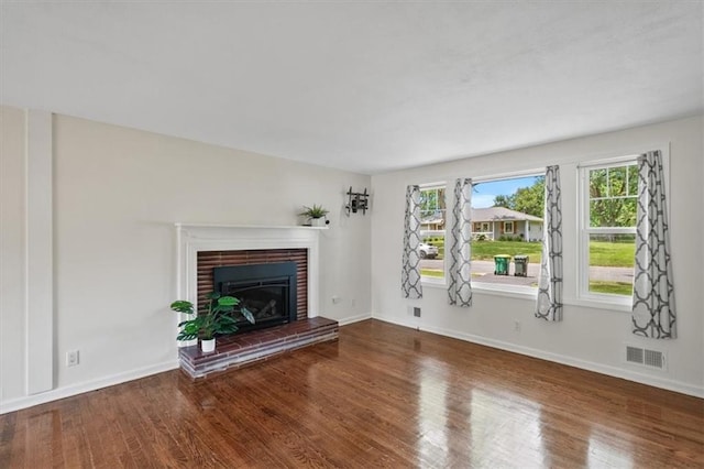 8815 W 81st St, Overland Park, KS 66204 - unfurnished living room featuring wood finished floors, a fireplace, and plenty of natural light