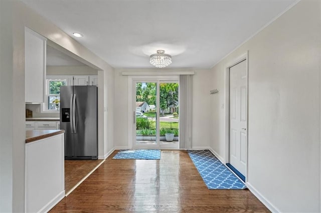 8815 W 81st St, Overland Park, KS 66204 - doorway featuring plenty of natural light, dark wood-style floors, and a chandelier