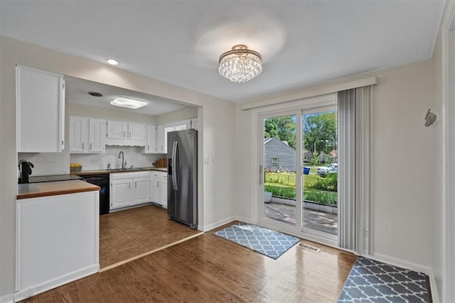 8815 W 81st St, Overland Park, KS 66204 - kitchen with stainless steel refrigerator with ice dispenser, a chandelier, white cabinetry, tasteful backsplash, and dark wood-style floors