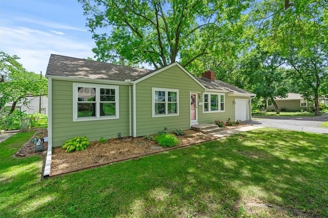 8815 W 81st St, Overland Park, KS 66204 - ranch-style home with driveway, a chimney, a front lawn, and a garage
