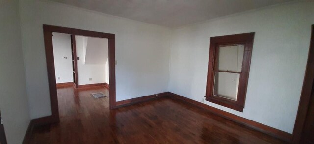 615 Church St, Neodesha, KS 66757 - spare room with dark wood-style floors and baseboards