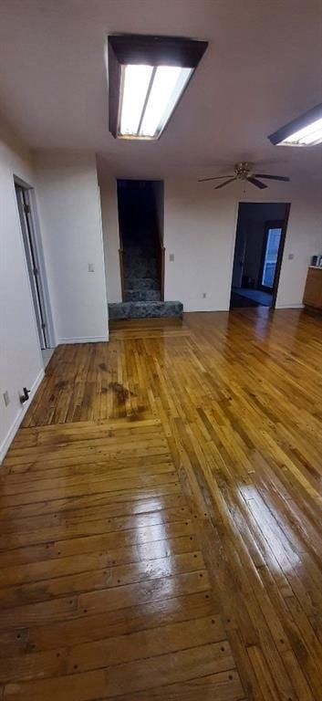 615 Church St, Neodesha, KS 66757 - unfurnished living room with wood-type flooring and ceiling fan