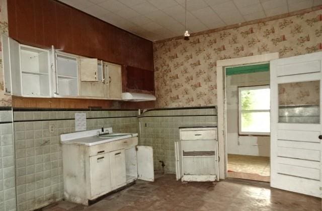 426 Pottawatomie St, Leavenworth, KS 66048 - kitchen featuring wallpapered walls, wainscoting, and ventilation hood